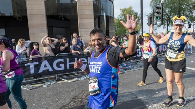 Man waving in a Diabetes UK running vest