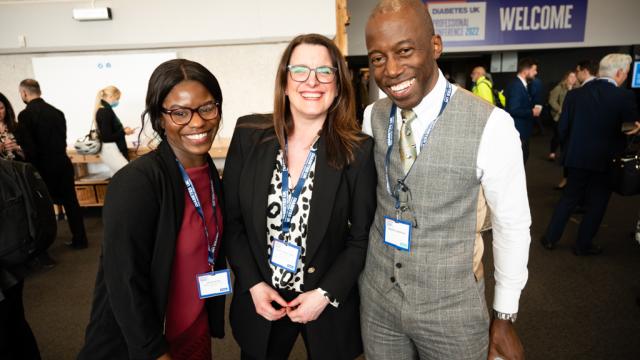 three people smiling at camera