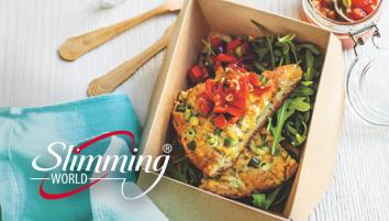 A small cardboard box with two sweetcorn fritter slices on top of rocket leaves and salsa.