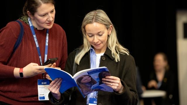 Two women looking at Diabetes UK Professional Conference programme