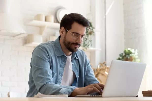 man sits at computer
