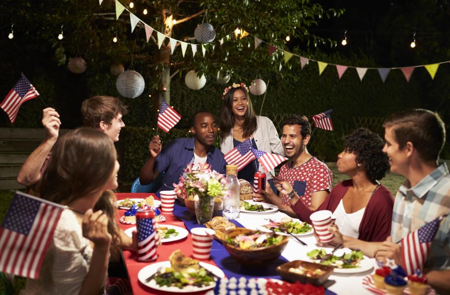 Diverse group of friends celebrate Independence Day in backyard party